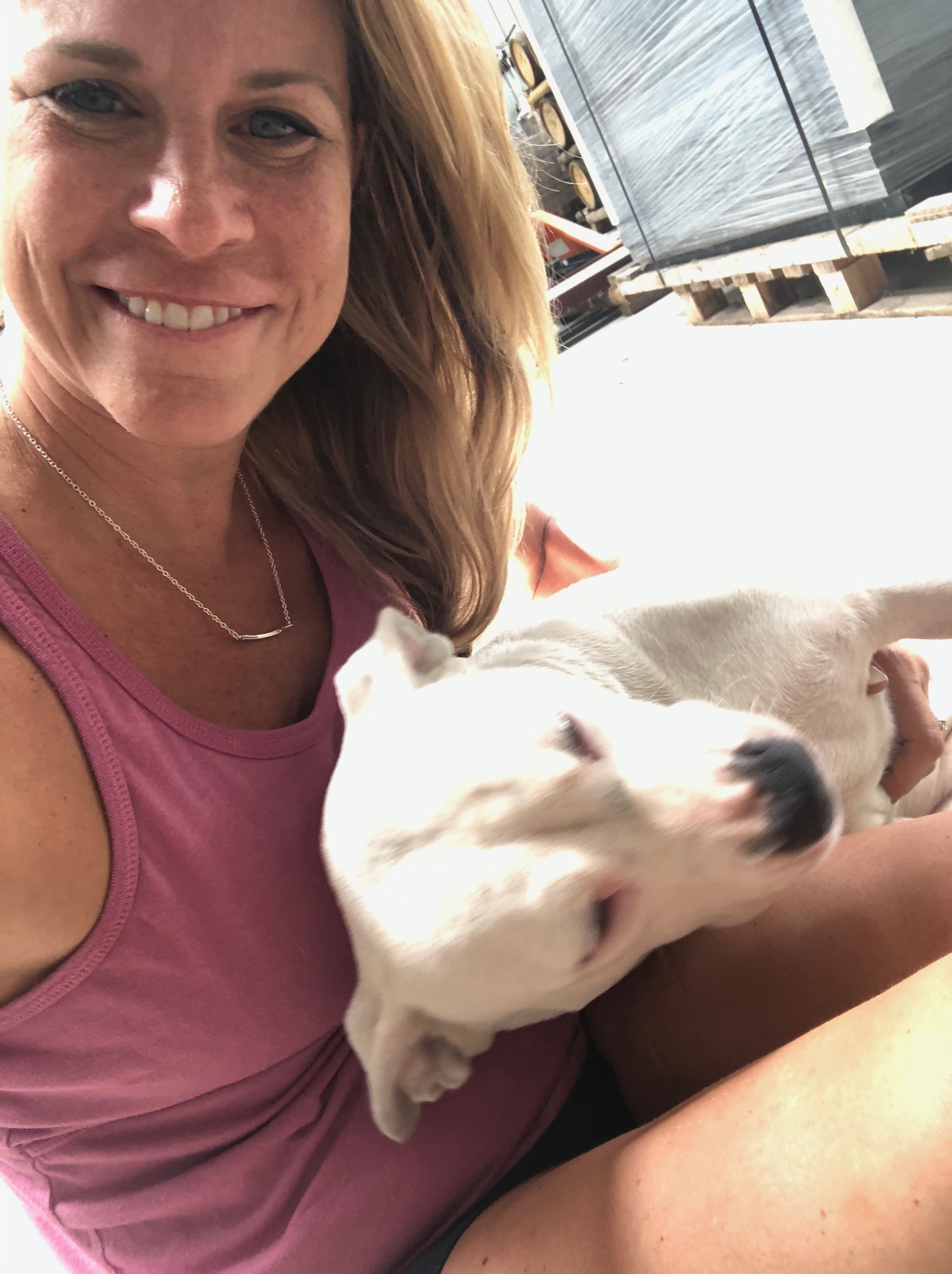 Keri with a dog at the distillery